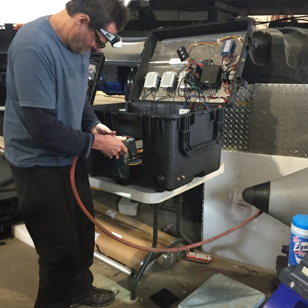 Technician preparing electronics case for live camera system
